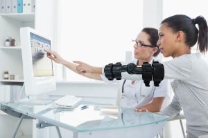 Doctor showing patient results on the computer in the office  